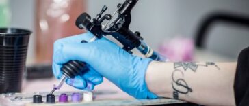Close-up shot of a tattoo artist's hand. They are prepping in studio.