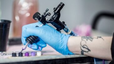 Close-up shot of a tattoo artist's hand. They are prepping in studio.
