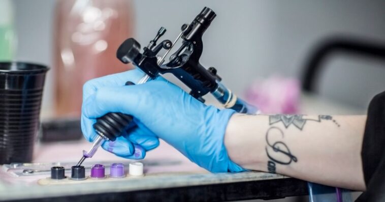 Close-up shot of a tattoo artist's hand. They are prepping in studio.