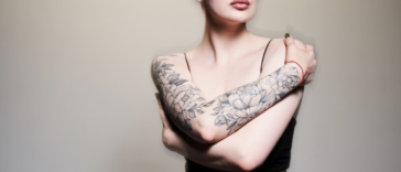 A woman with tattoos on her arms.