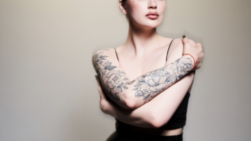 A woman with tattoos on her arms.