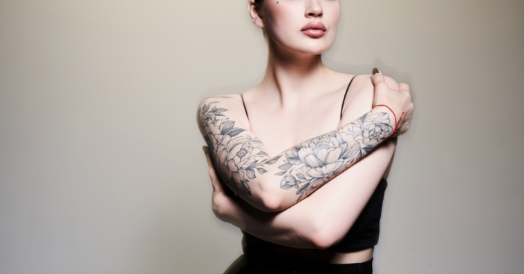 A woman with tattoos on her arms.