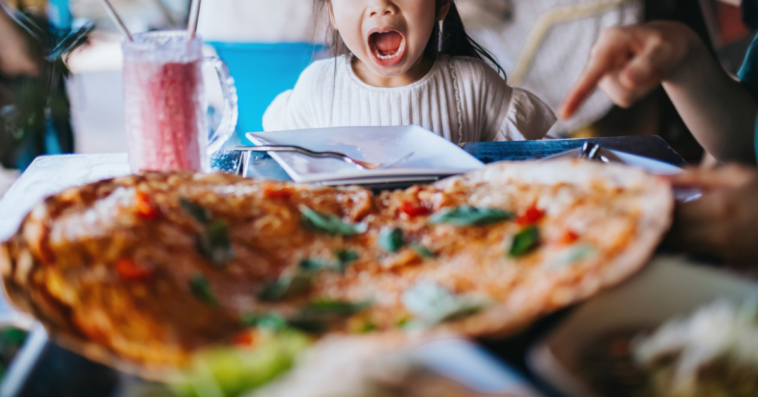 Young girl screaming in a restaurant