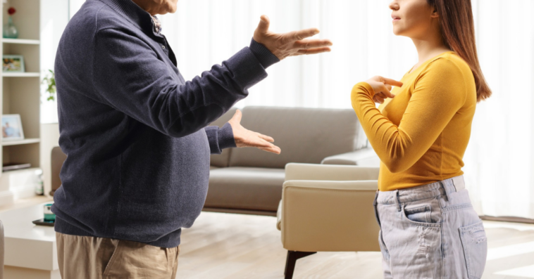 father and daughter arguing in living room