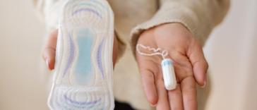 woman holding menstrual products