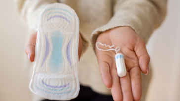 woman holding menstrual products