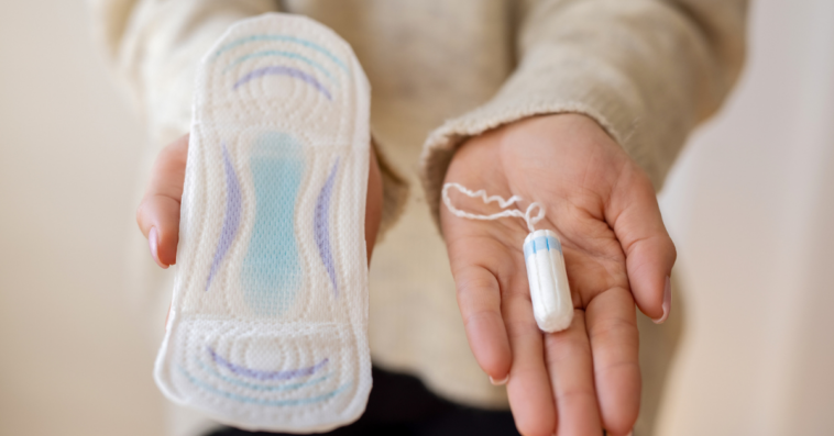 woman holding menstrual products