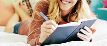 young woman writing in journal