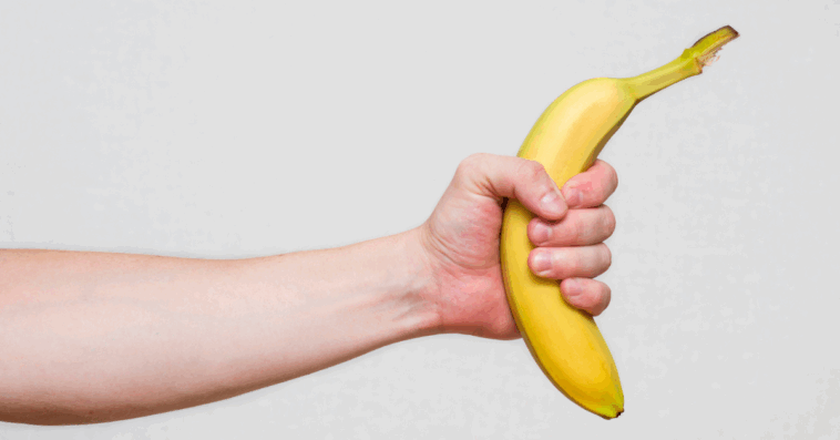 A man holding out a bannana