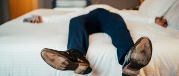 Faceless businessman resting in hotel room.