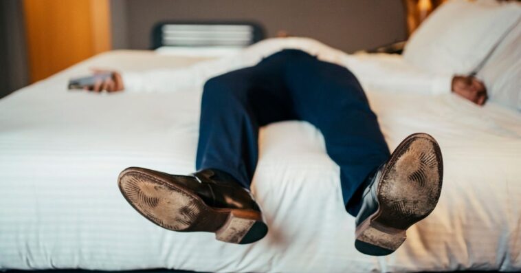 Faceless businessman resting in hotel room.