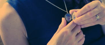 Person holding a locket necklace
