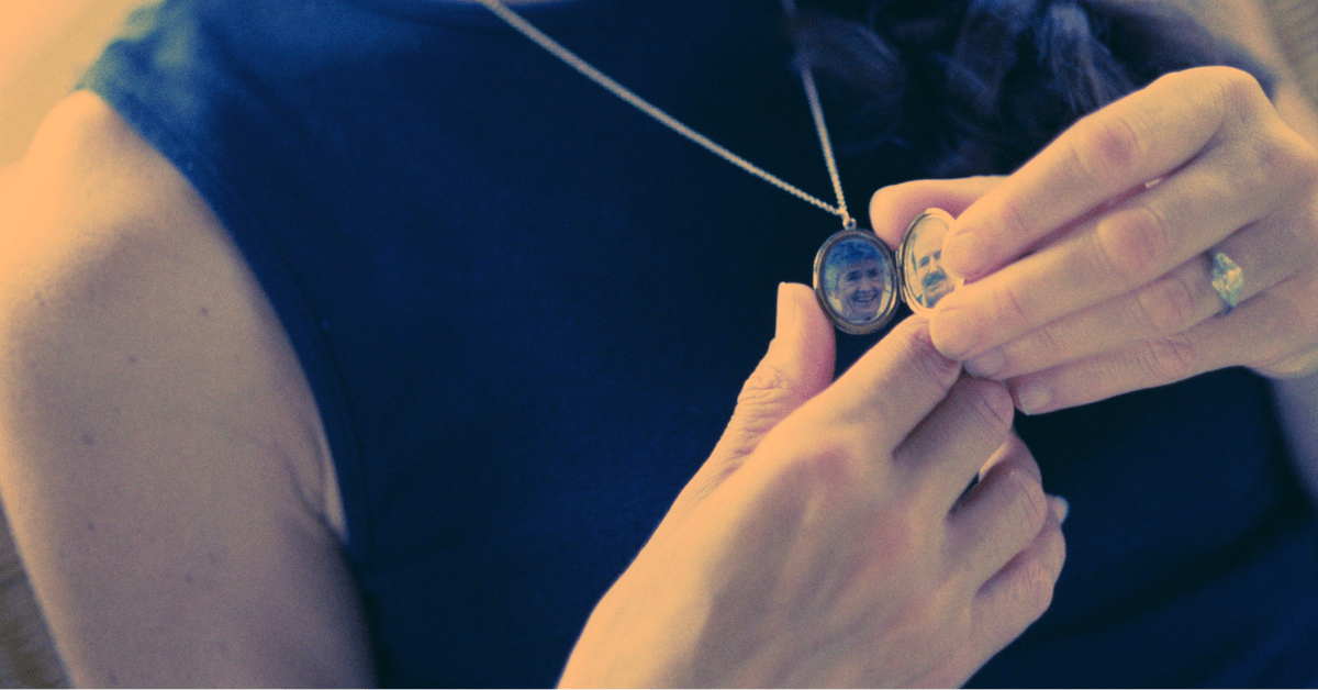 Person holding a locket necklace