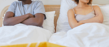 Couple fighting in bed