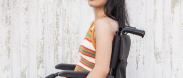 Young handicapped girl with depressed expression looks directly into the camera.