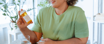 A woman holding a prescription bottle.