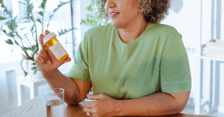 A woman holding a prescription bottle.