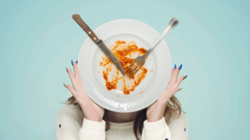 woman holding up a dirty dish