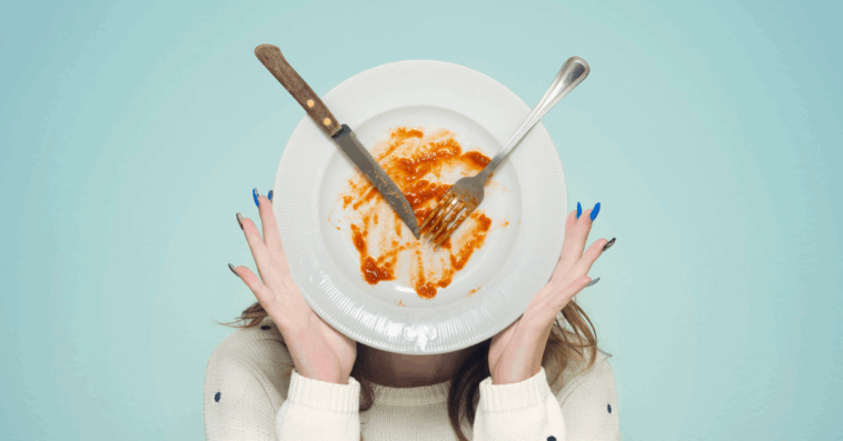 woman holding up a dirty dish