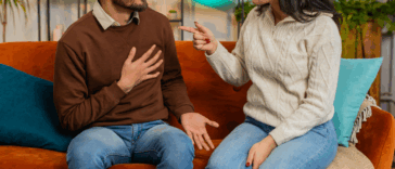 young Indian couple arguing on couch