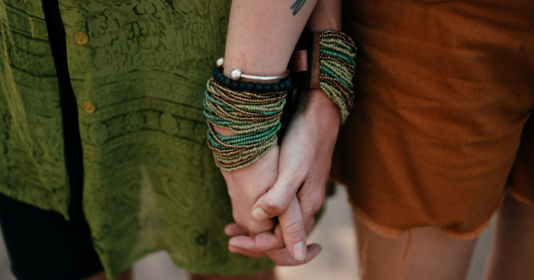 two women holding hands