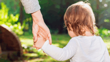 woman holding little girl's hand