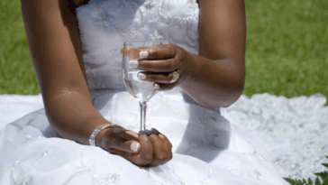 Bride holding flute glass filled with water