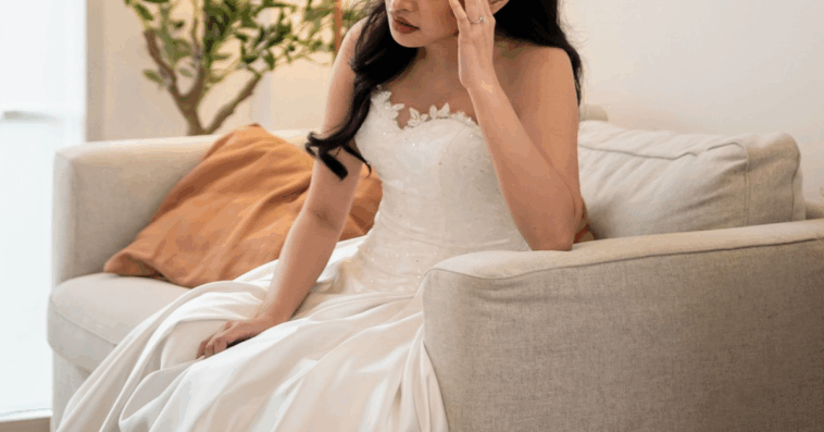 sad bride sitting alone on loveseat