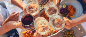 A group of people clinking wine glasses.