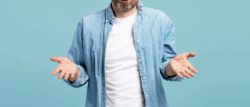 A man shrugging his shoulders and holding out his hands.