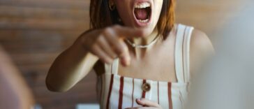 Displeased woman screaming in frustration while arguing with her boyfriend.
