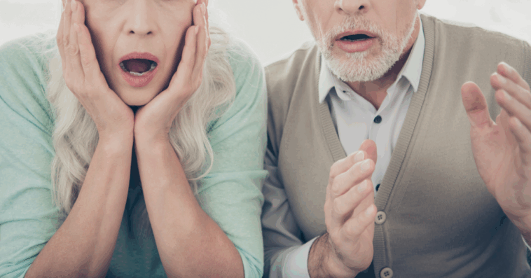 An older couple with shocked expressions on thier face.