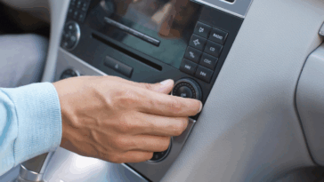 A man tuning his car radio.