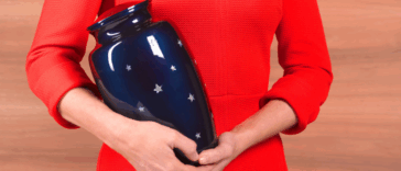 A woman holding an urn.