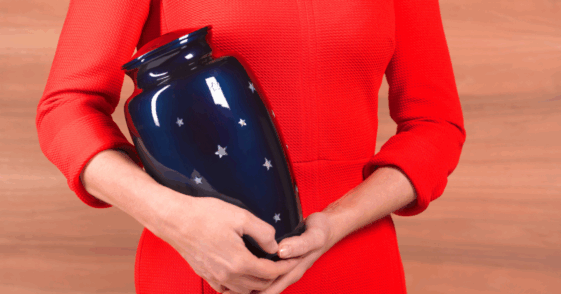 A woman holding an urn.