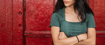 A woman standing with her arms crossed.