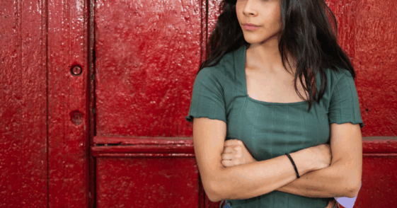 A woman standing with her arms crossed.