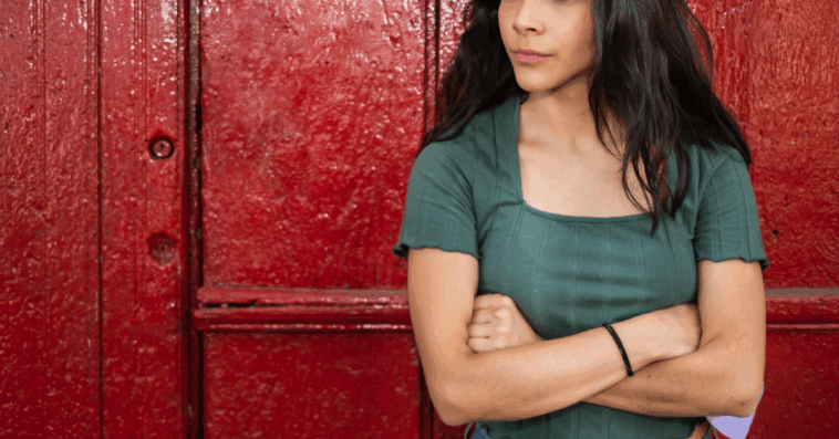A woman standing with her arms crossed.