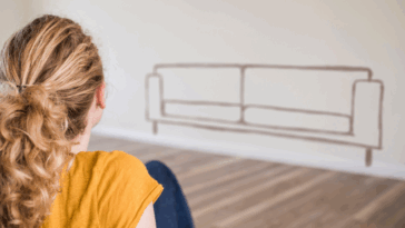 woman looking at silhouette of couch on the wall