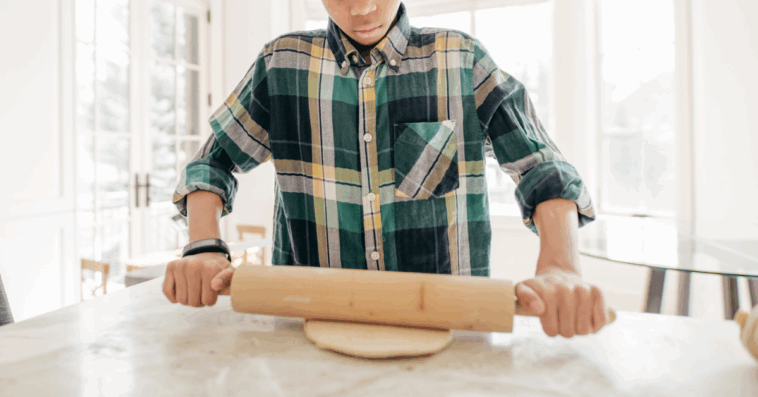Young boy learning to bake