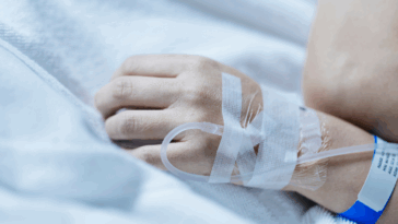 A woman with an IV attached to her arm.