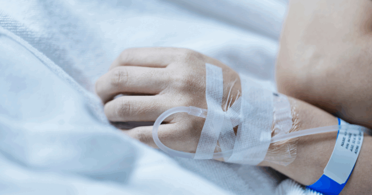 A woman with an IV attached to her arm.