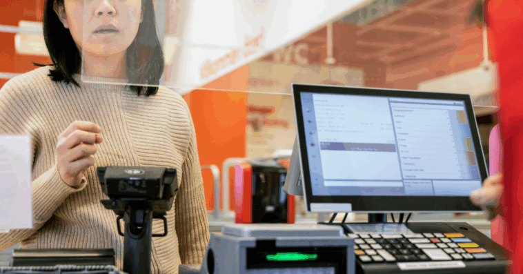 person standing in front of cash register