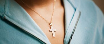Close up of a cross necklace on woman.