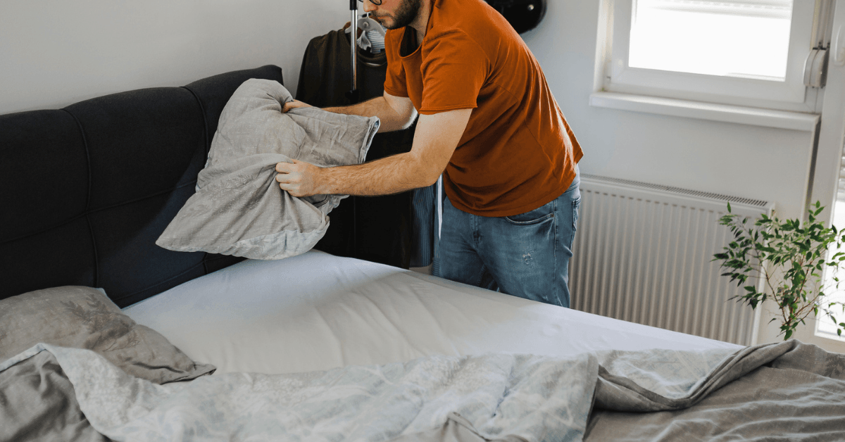 Guy making the bed
