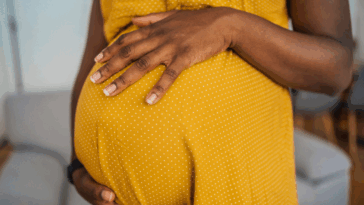 Pregnant woman holding her belly