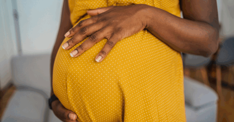 Pregnant woman holding her belly