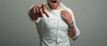 A man screaming and pointing his finger at the camera.