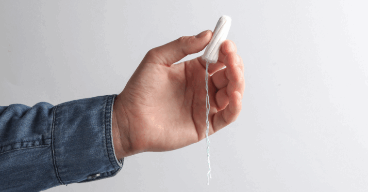 Guy holding a tampon