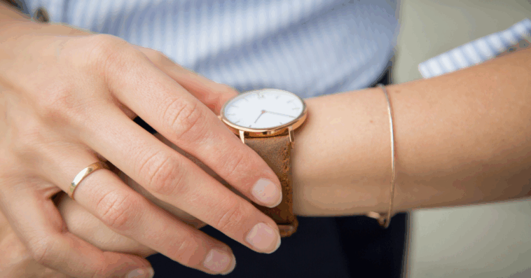 A woman looking at her watch.
